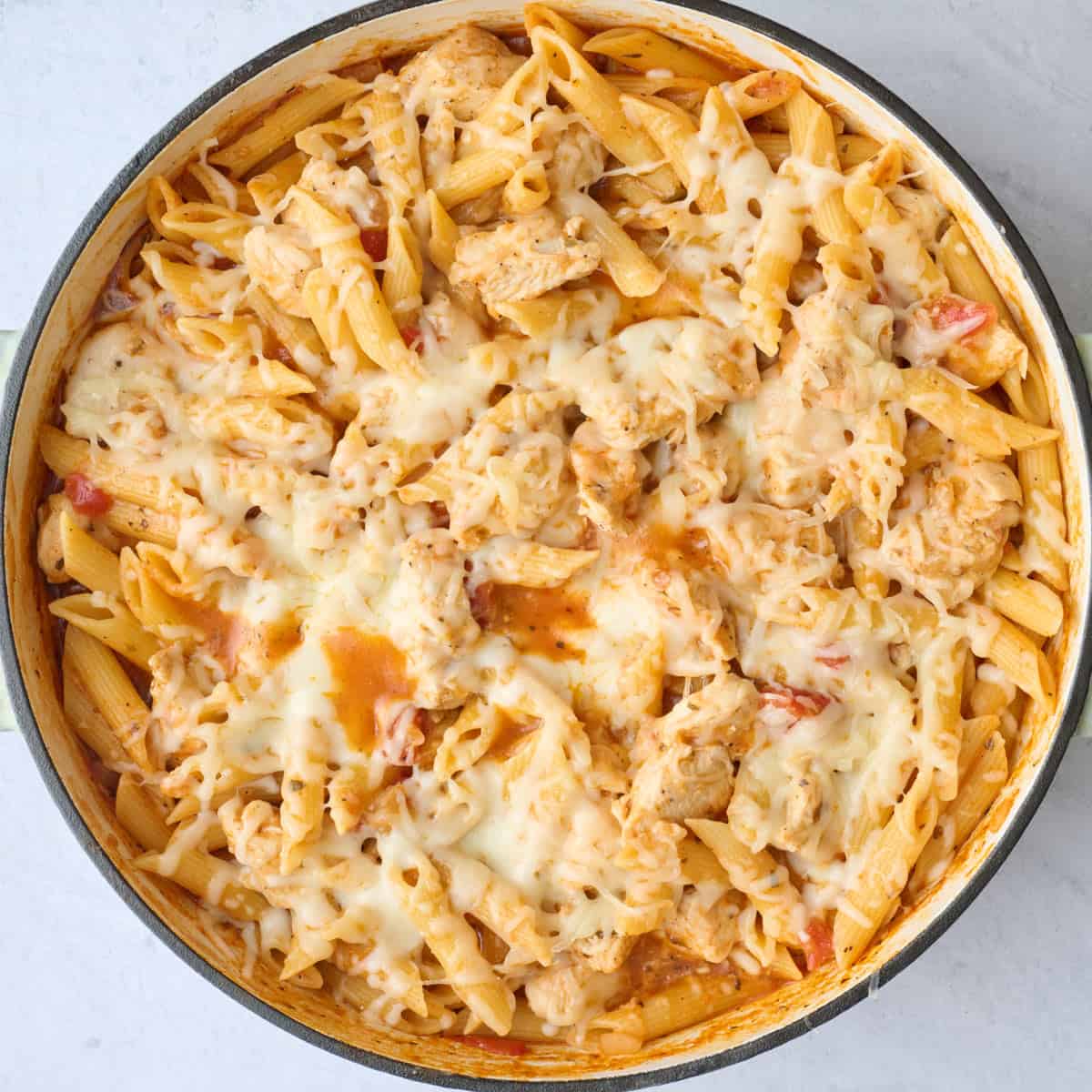 Pasta in the pot after cheese melted on top.