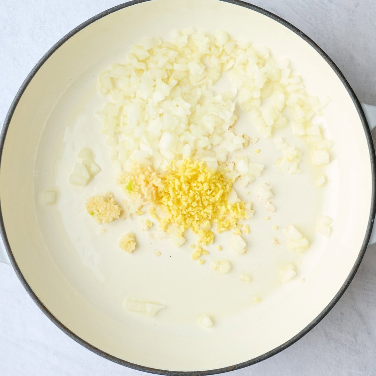 Onions, garlic and ginger in a large skillet before cooking them.