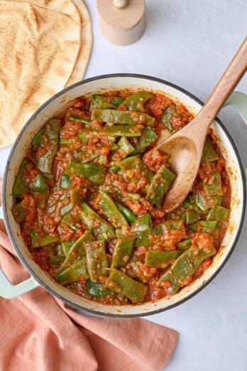 Authentic Lebanese green beans recipe called Loubieh Bi Zeit, made with a spiced tomato based and flat style green beans.