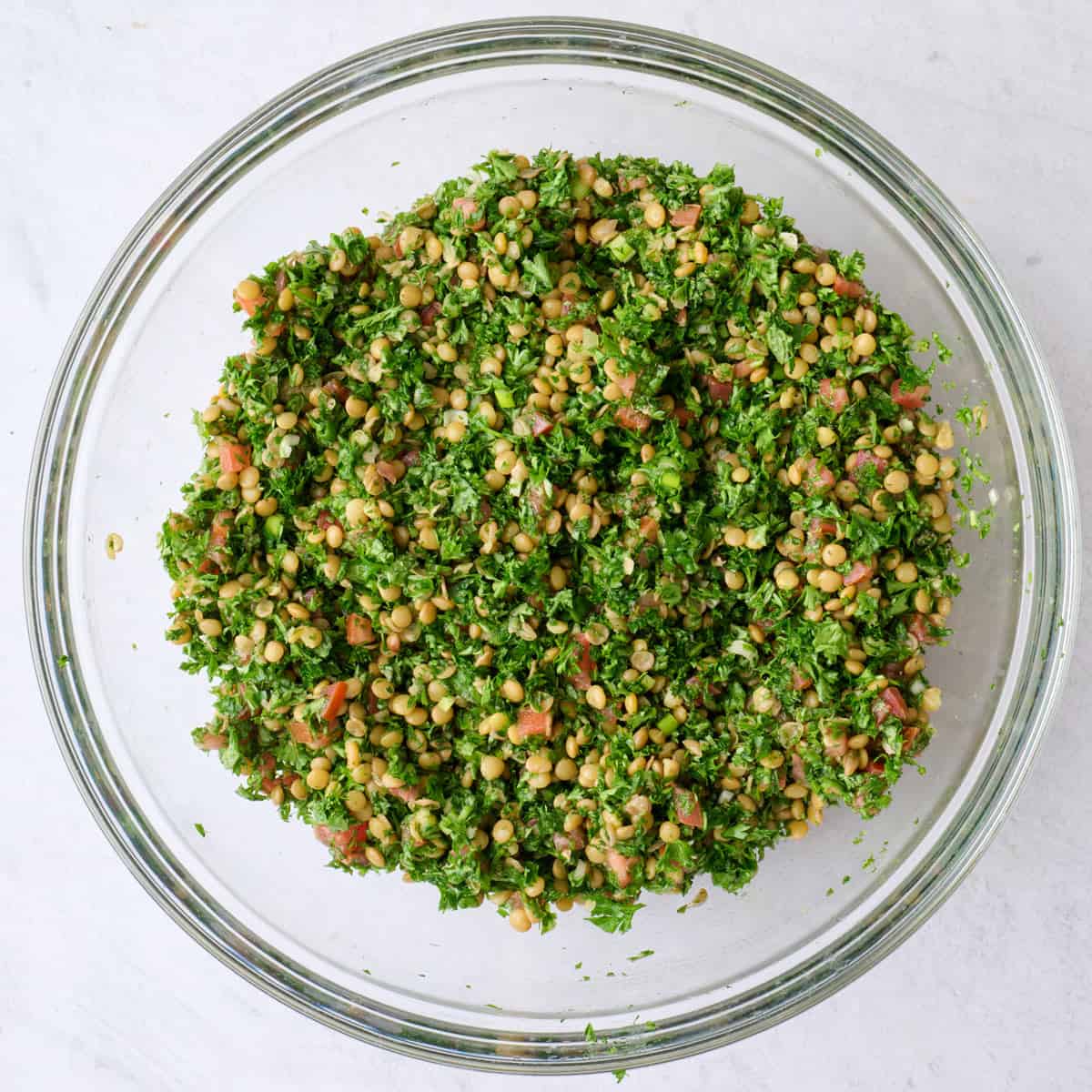 Herb and lentil salad after tossing together in lemon dressing.