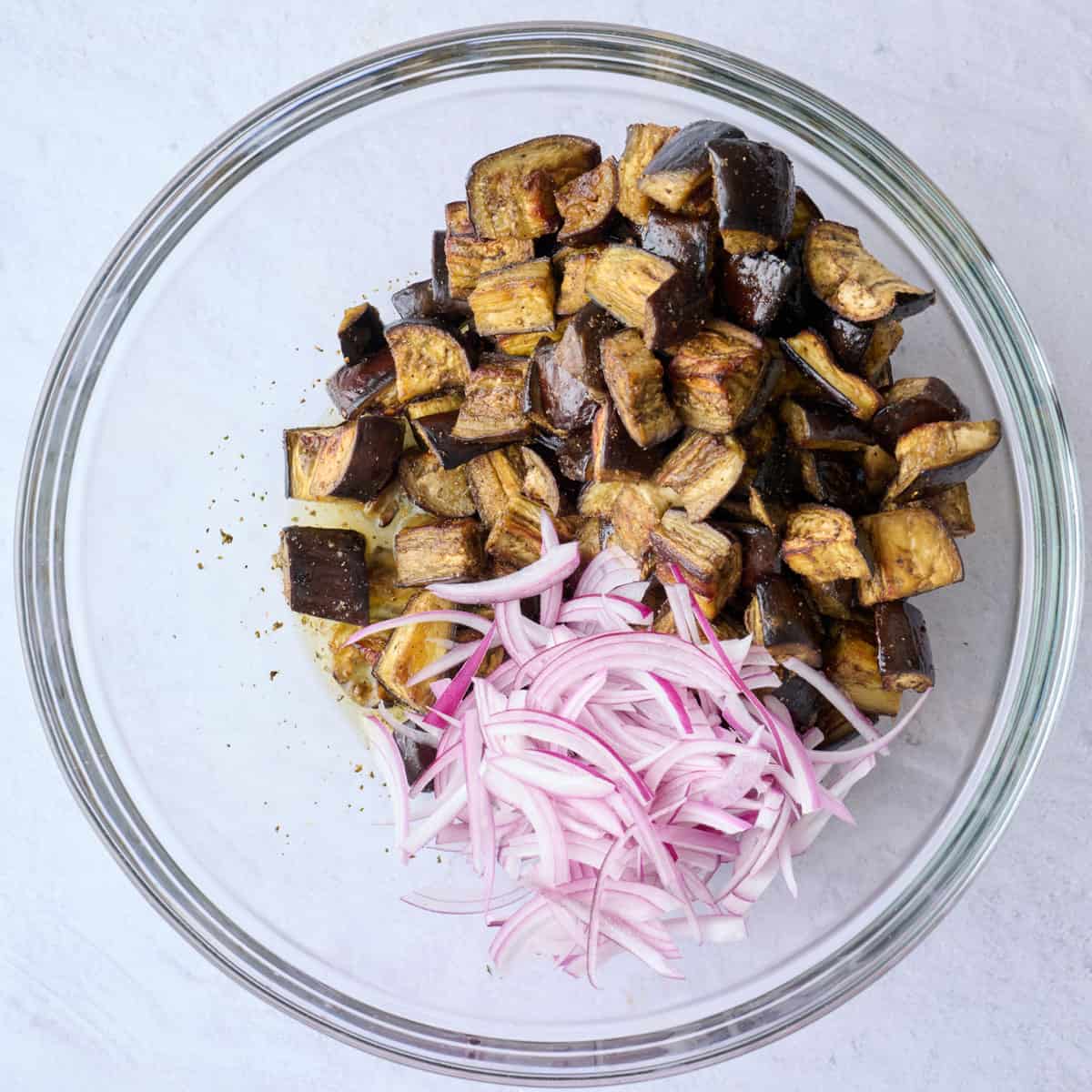 Roasted eggplant and onions added on top of dressing before tossing.