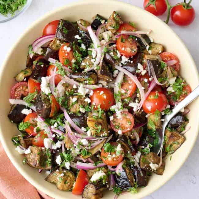 Mediterranean eggplant salad made with tomatoes, onions and herbs, tossed with a bright dressing.