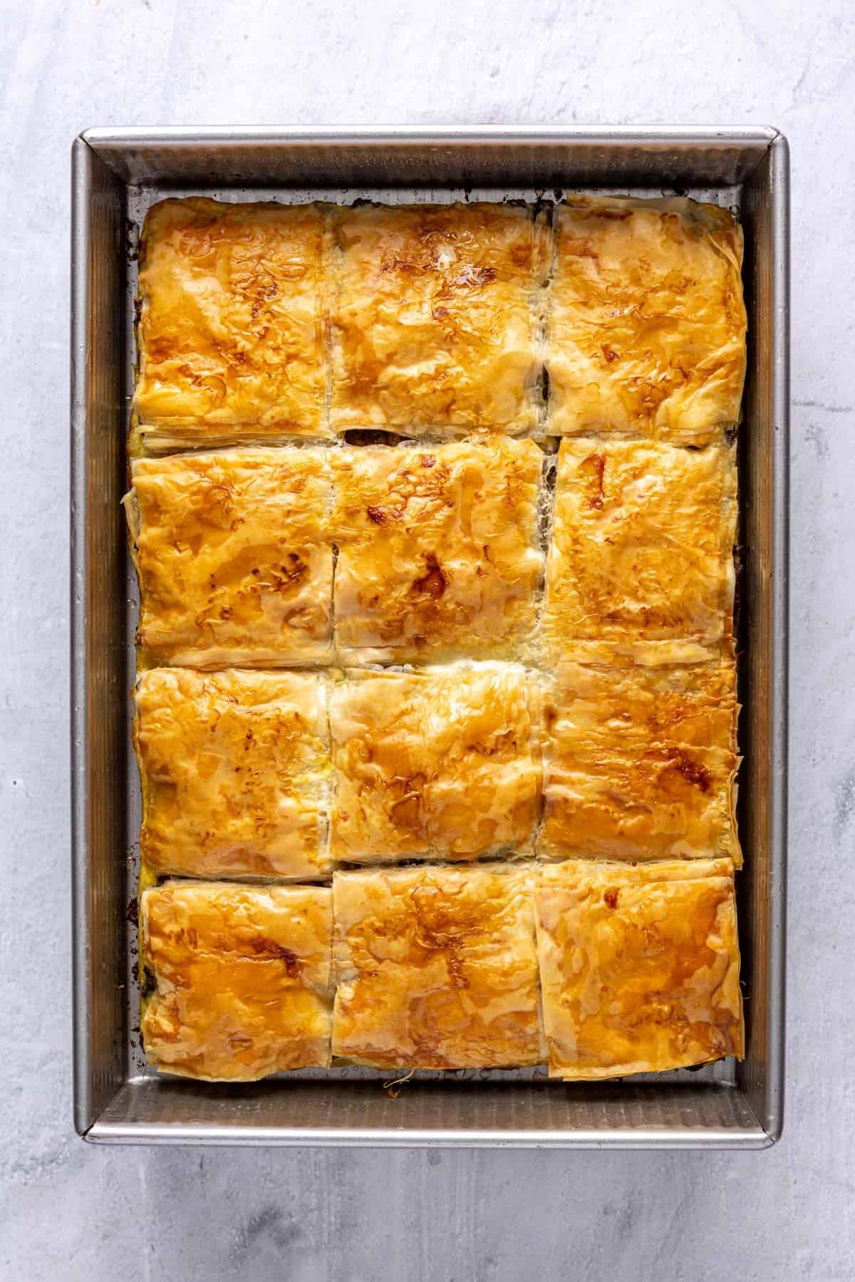 The meat pie in a baking dish after removing it from the oven.