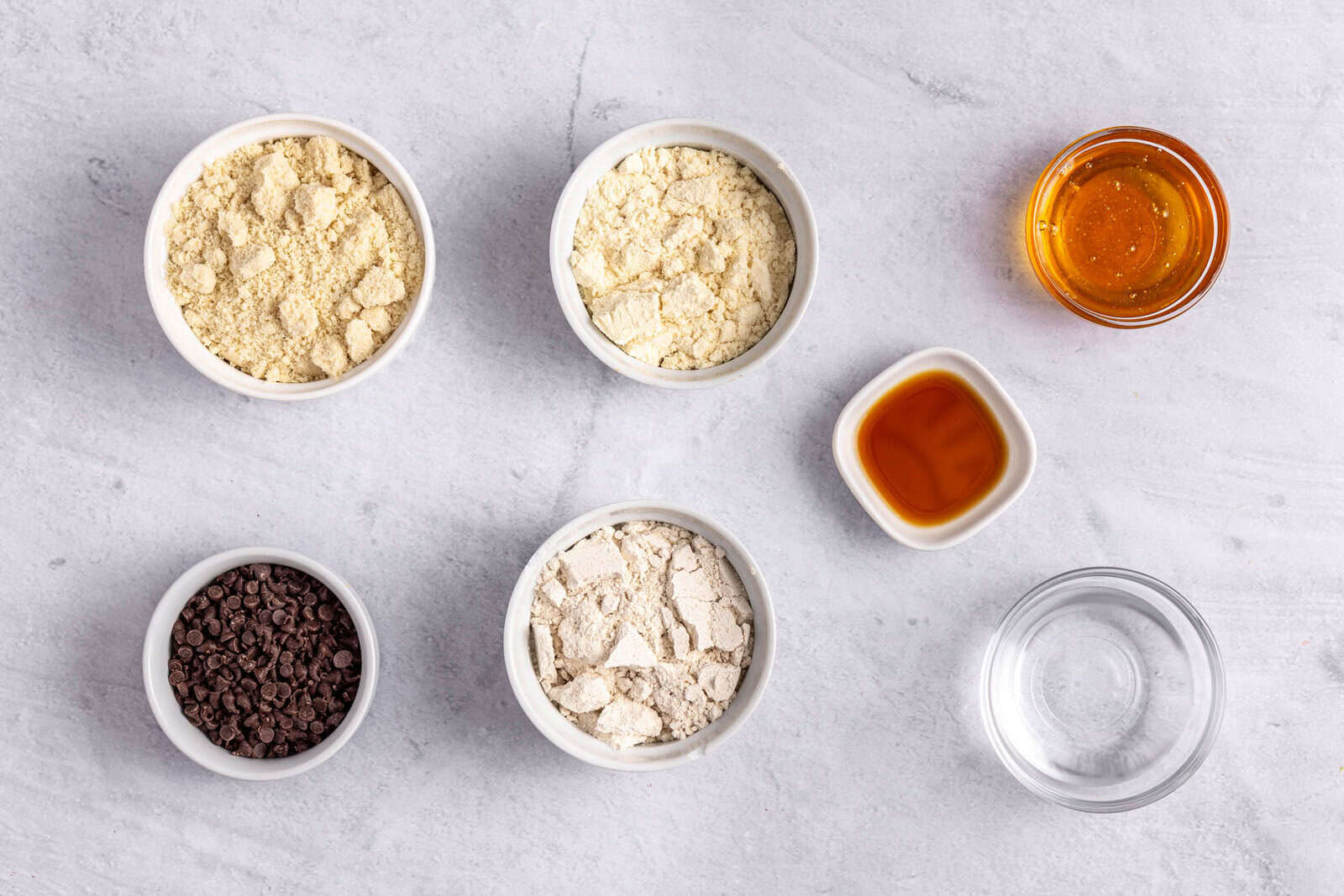 Ingredients for protein balls recipe: almond flour, protein powder, oat flour, honey, and water.