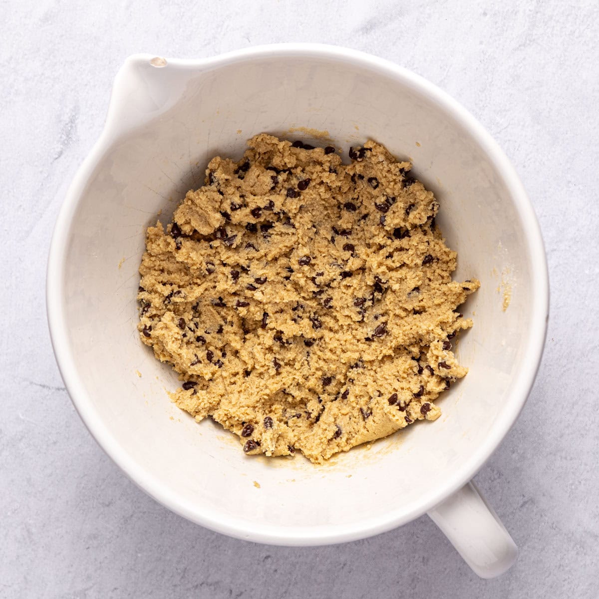 Gluten free protein balls mixture with chocolate chips folded in before shaping.