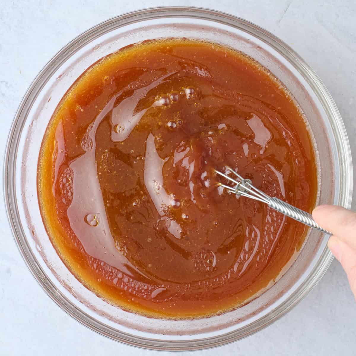 Sauce ingredients being whisked together.