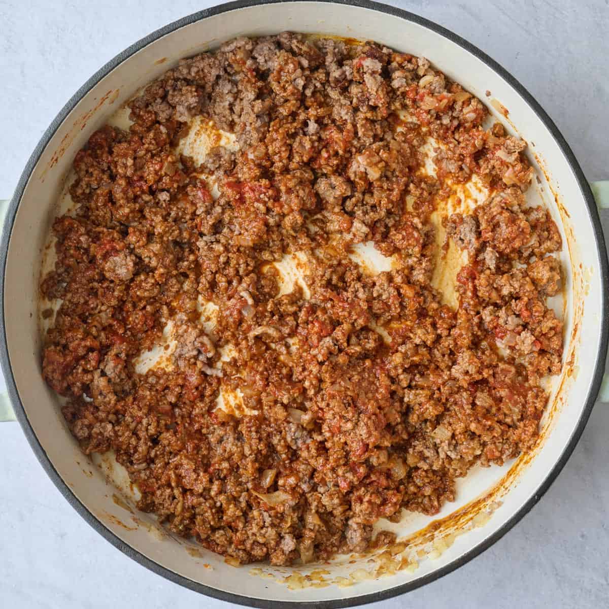 After mixing cooked with beef with tomato paste and taco seasonings.