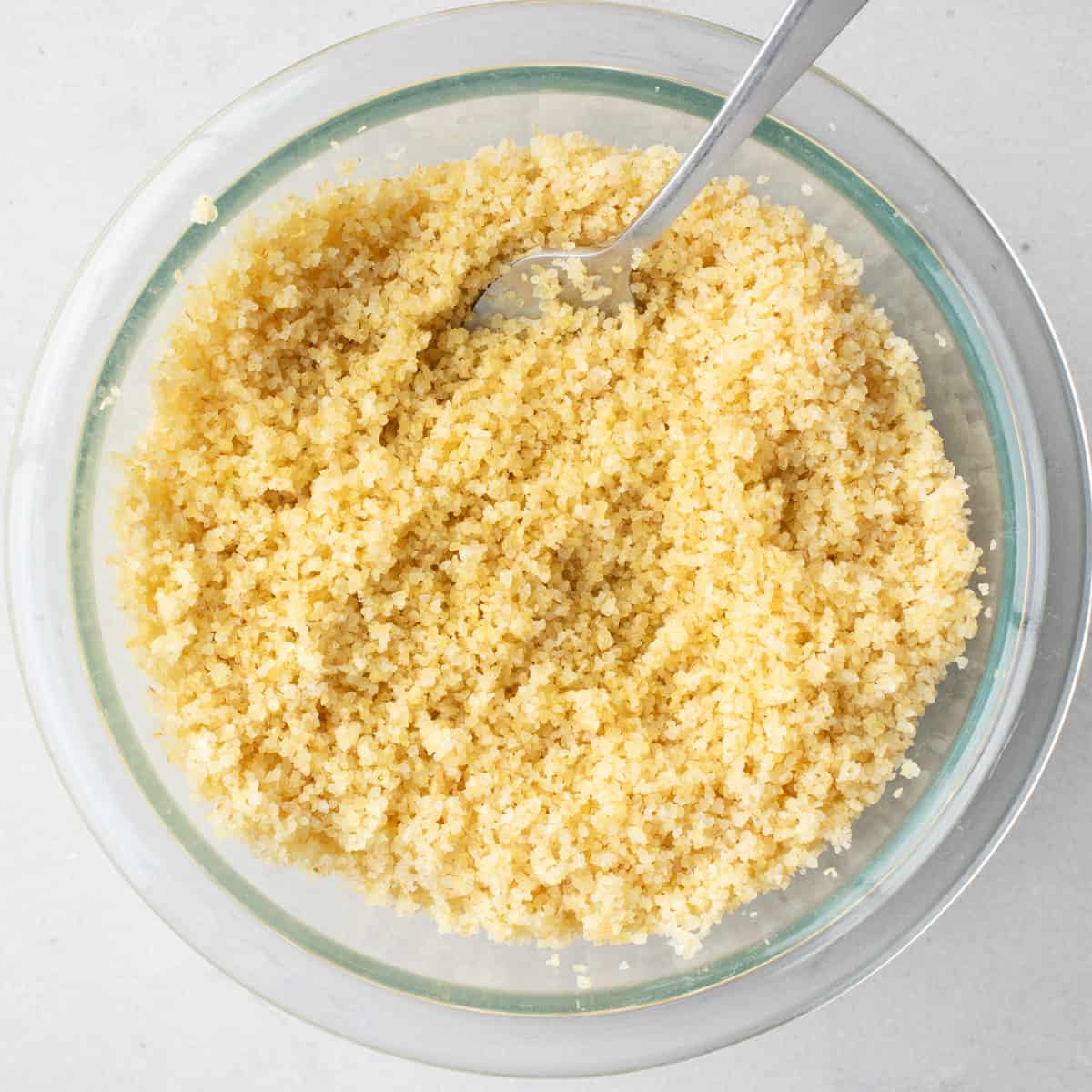 Bulgur in a bowl after soaking and fluffing with a fork.