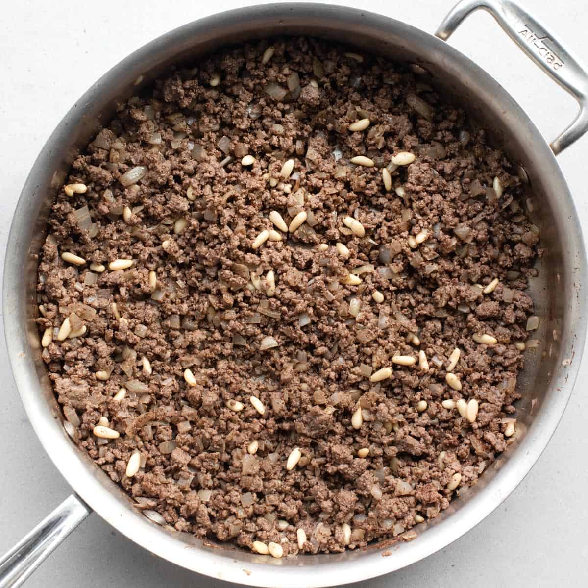 Beef hashweh ground beef mixture after combining in pan.