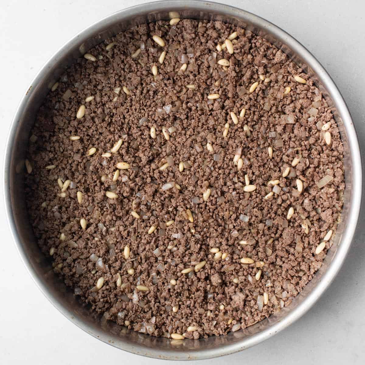 Beef hashweh added on top of beef bulgur dough.