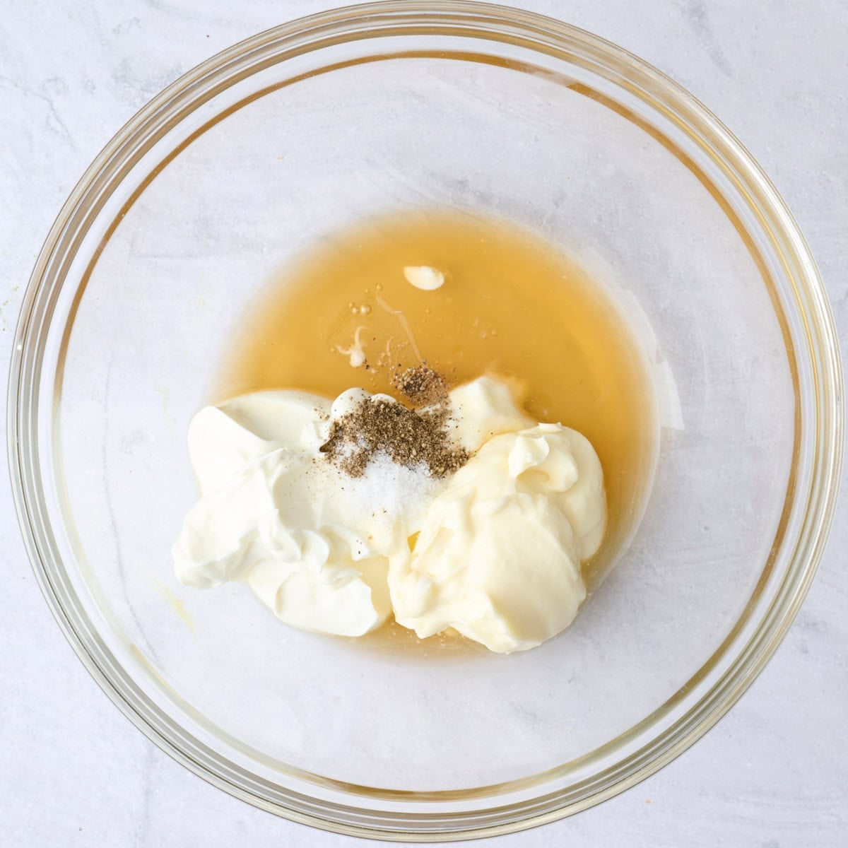 Greek yogurt, mayo, vinegar, honey, salt and pepper in a large bowl before whisking.