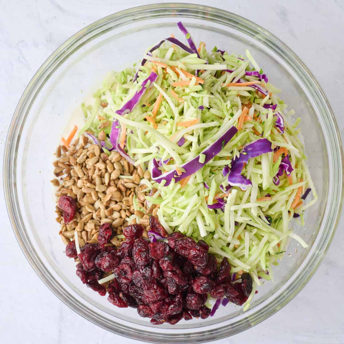 Broccoli slaw mix, dried cranberries and sunflower seeds added before tossing.