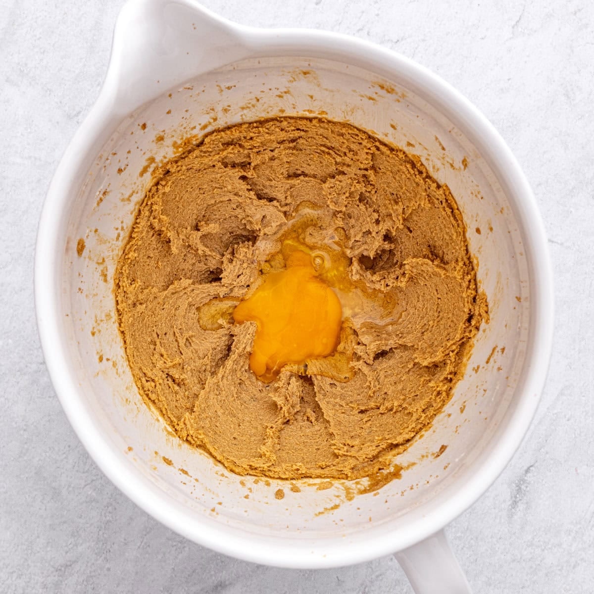 Egg added to creamed butter and sugar before mixing in.