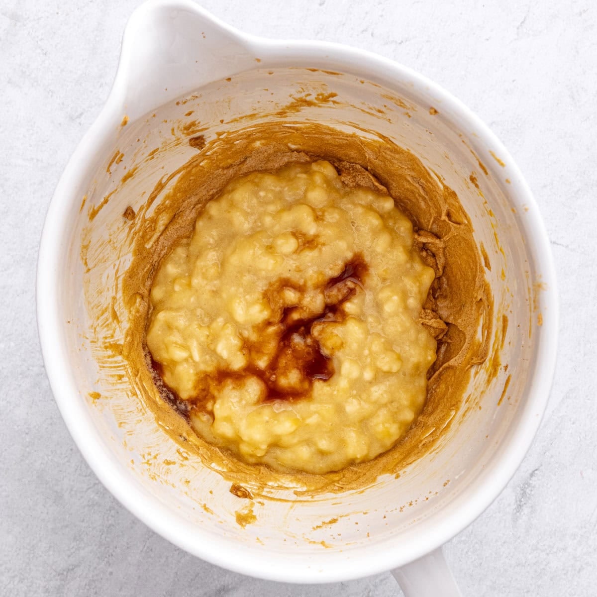 Mashed bananas and vanilla added to creamed butter and egg mixture for bread batter.