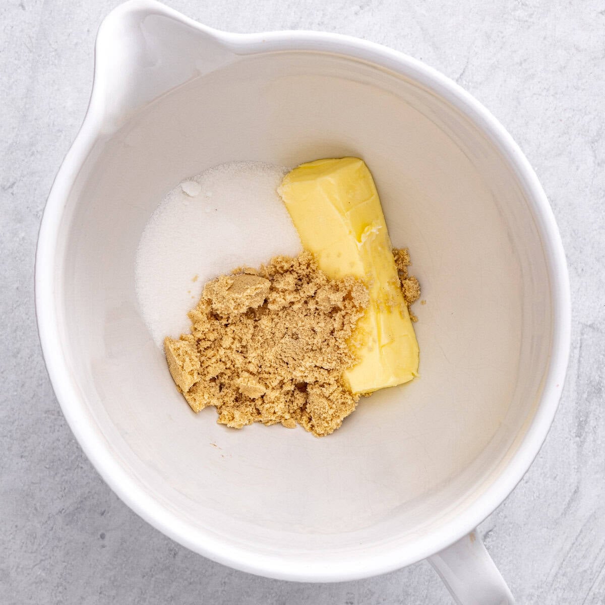 Softened butter, brown sugar, and granulated sugar in the bowl of a stand mixer before combining.