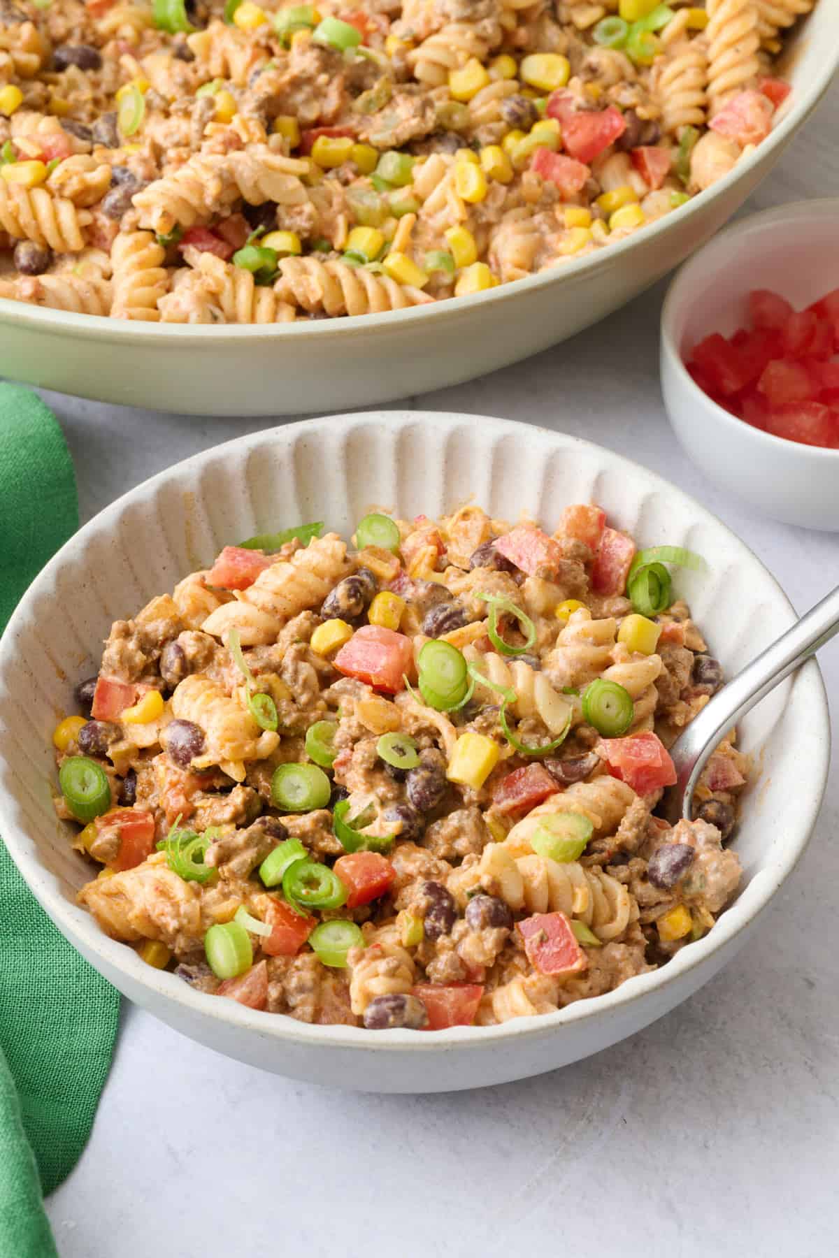 Best taco pasta salad recipe made with a a creamy, cheesy sauce, beef ,beans, corn, and tomatoes.