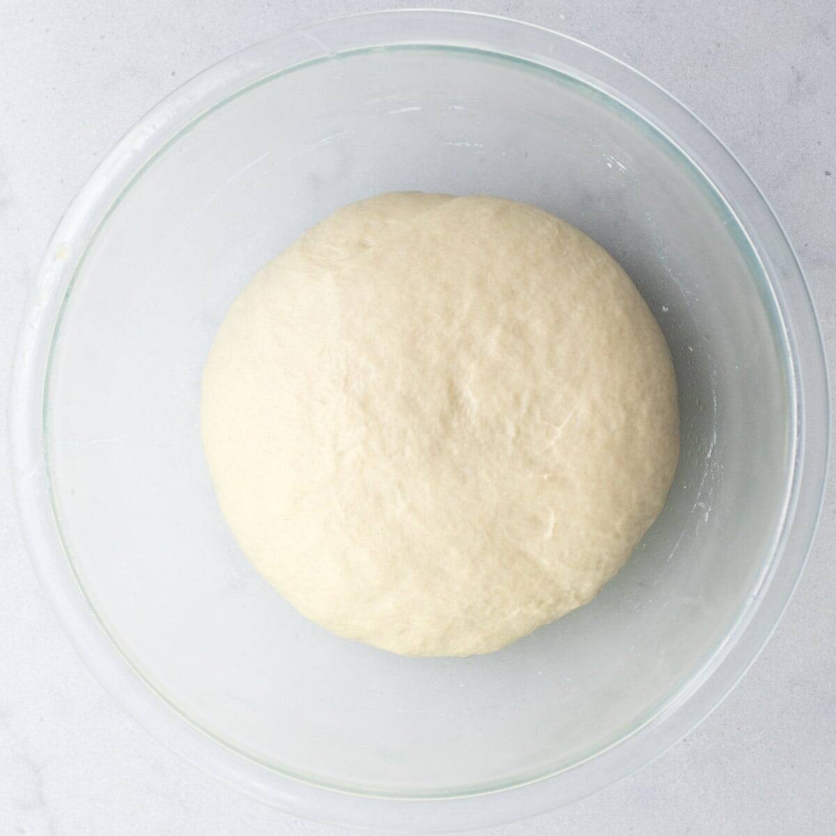 Dough ball after combined and formed in a bowl.