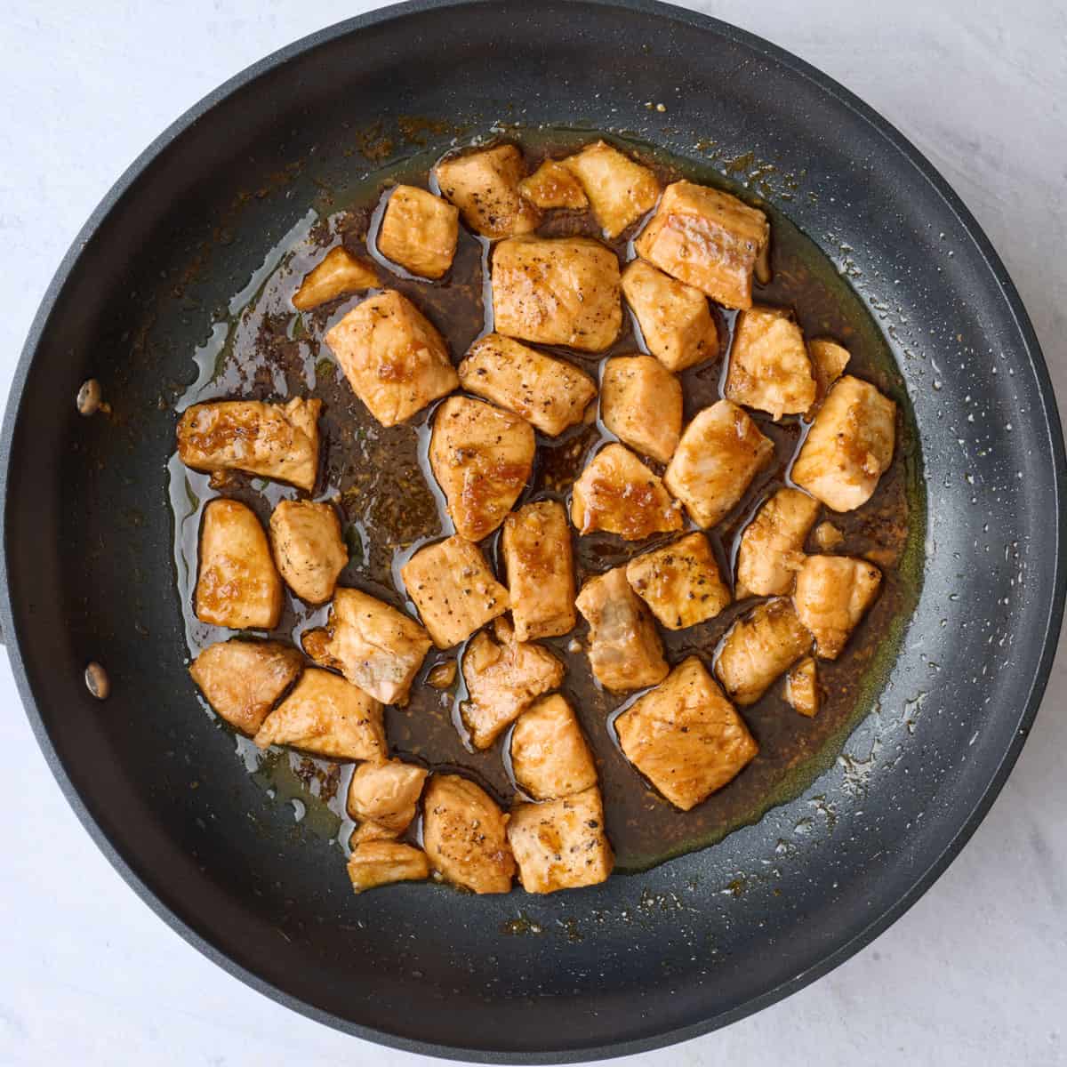 After sauce thickens and coats salmon cubes.
