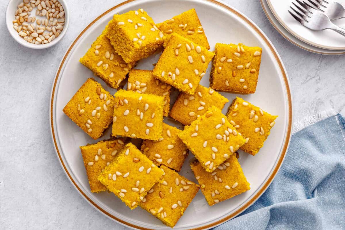 Best sfouf recipe, or turmeric cake, cut into squares on a plate.