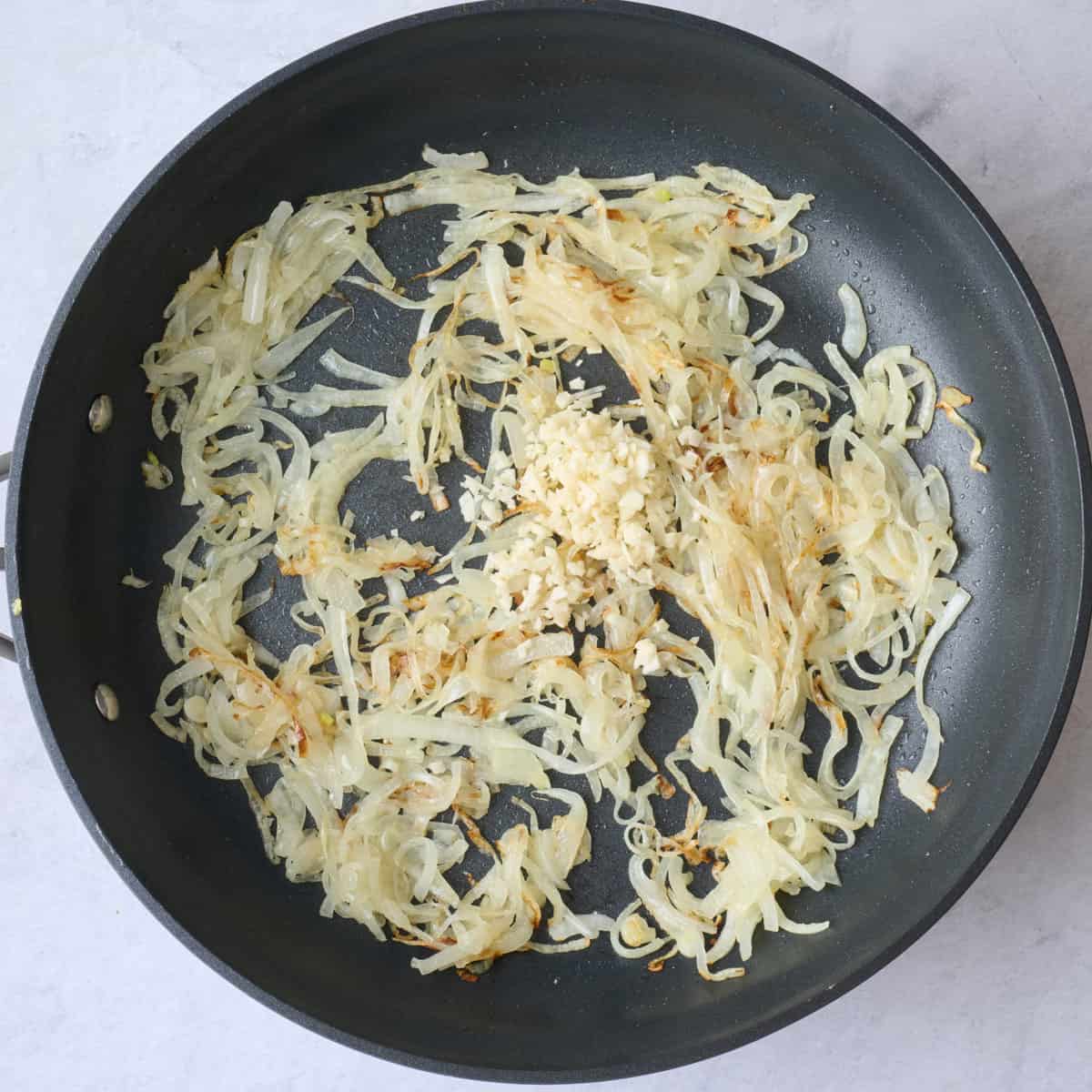 After sauteeing and golden with garlic added.