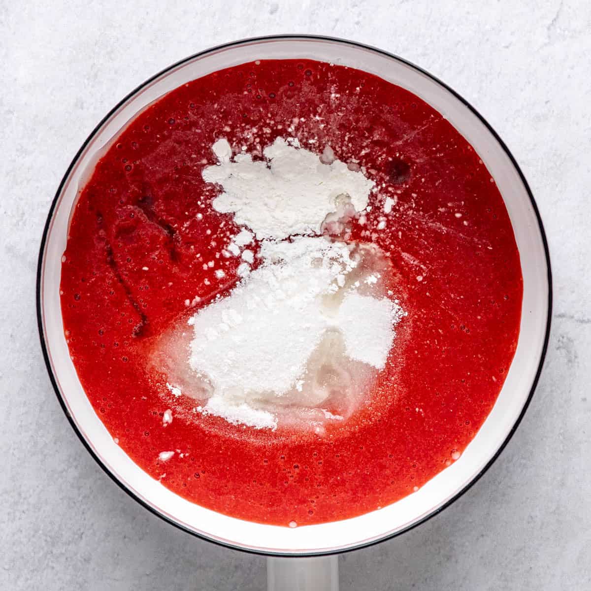 Strawberries after pureeing in a saucepan with sugar, cornstarch and lemon juice added before mixing.