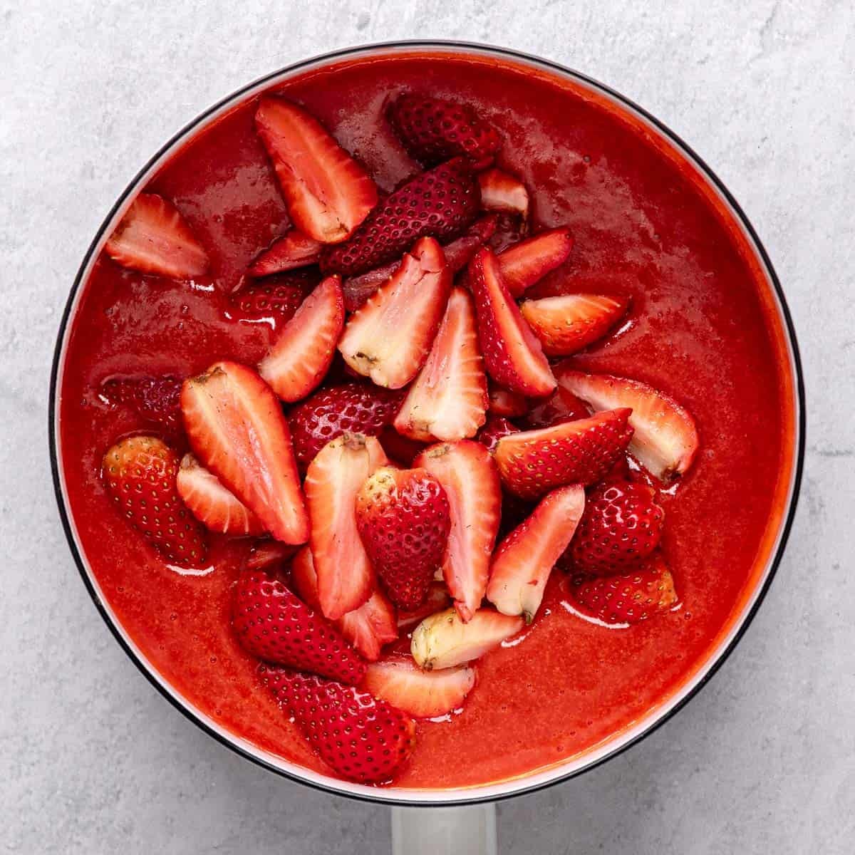 Remaining quartered strawberries added to sauce before combining.