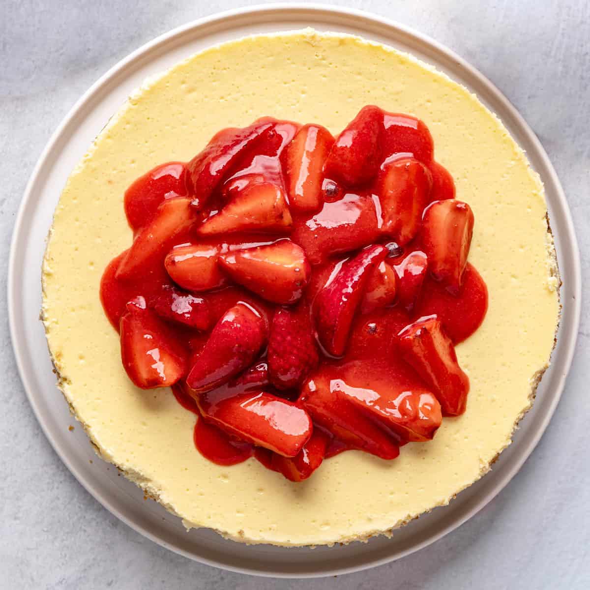 Chilled strawberry topping spooned over cheesecake.