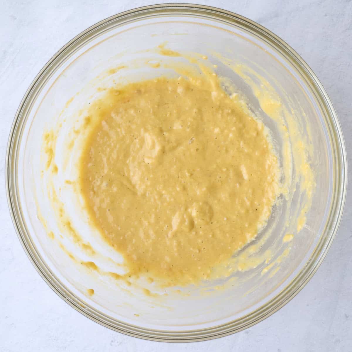 The batter after mixing together the eggs, flour, soy sauce, sesame oil, garlic, salt and pepper in a large bowl.