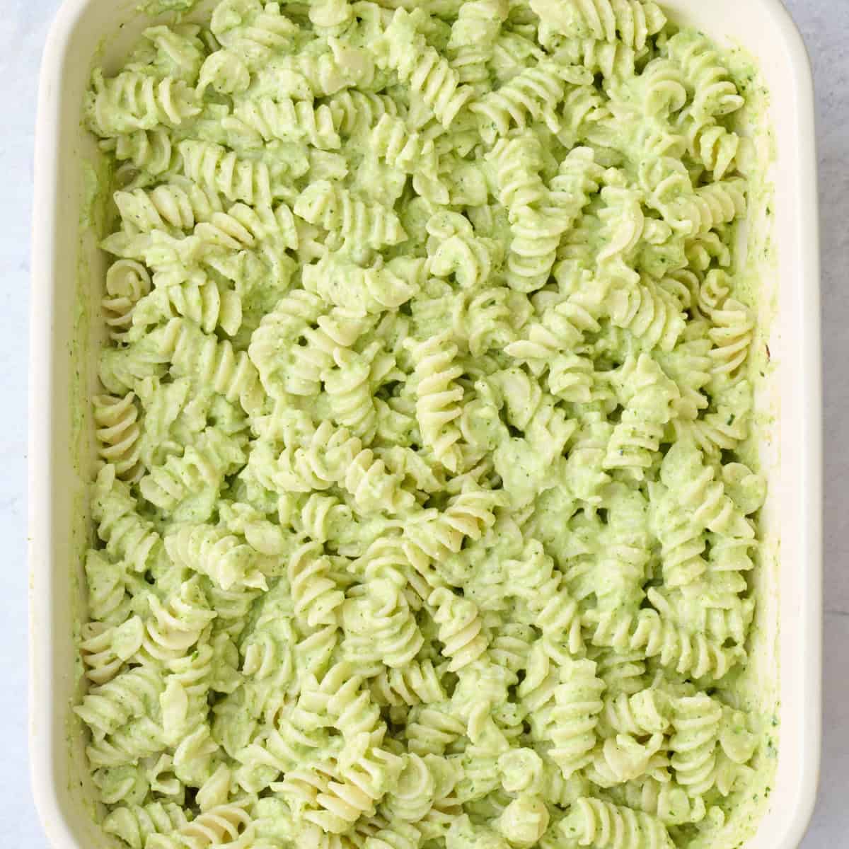 Pasta after tossing together with creamy green sauce.