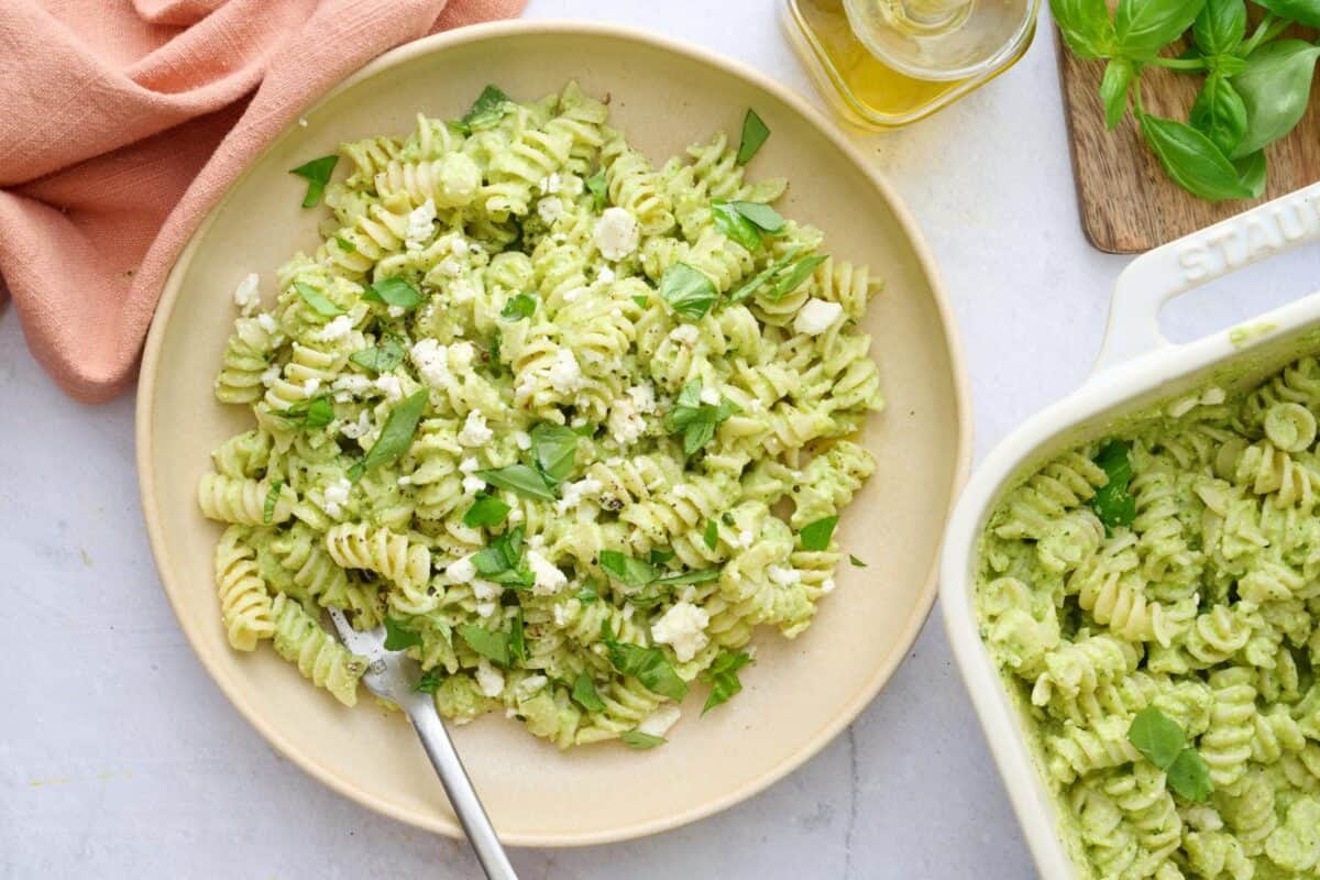 Pasta with green sauce made with feta served in a bowl.