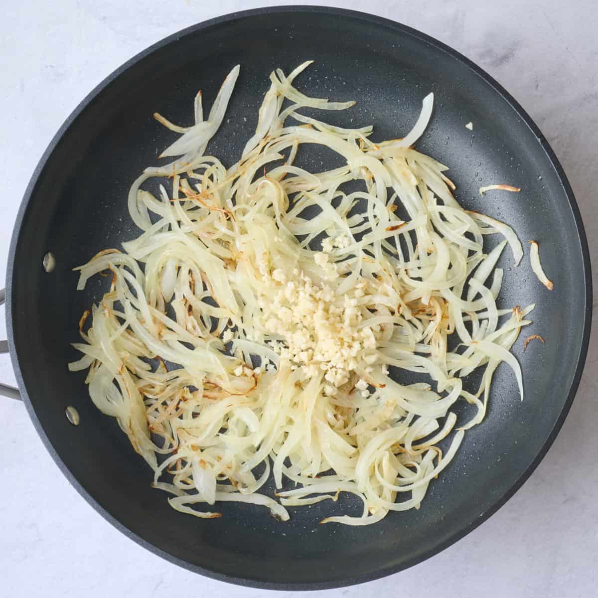 Onion in skillet after cooking with garlic added before cooking.