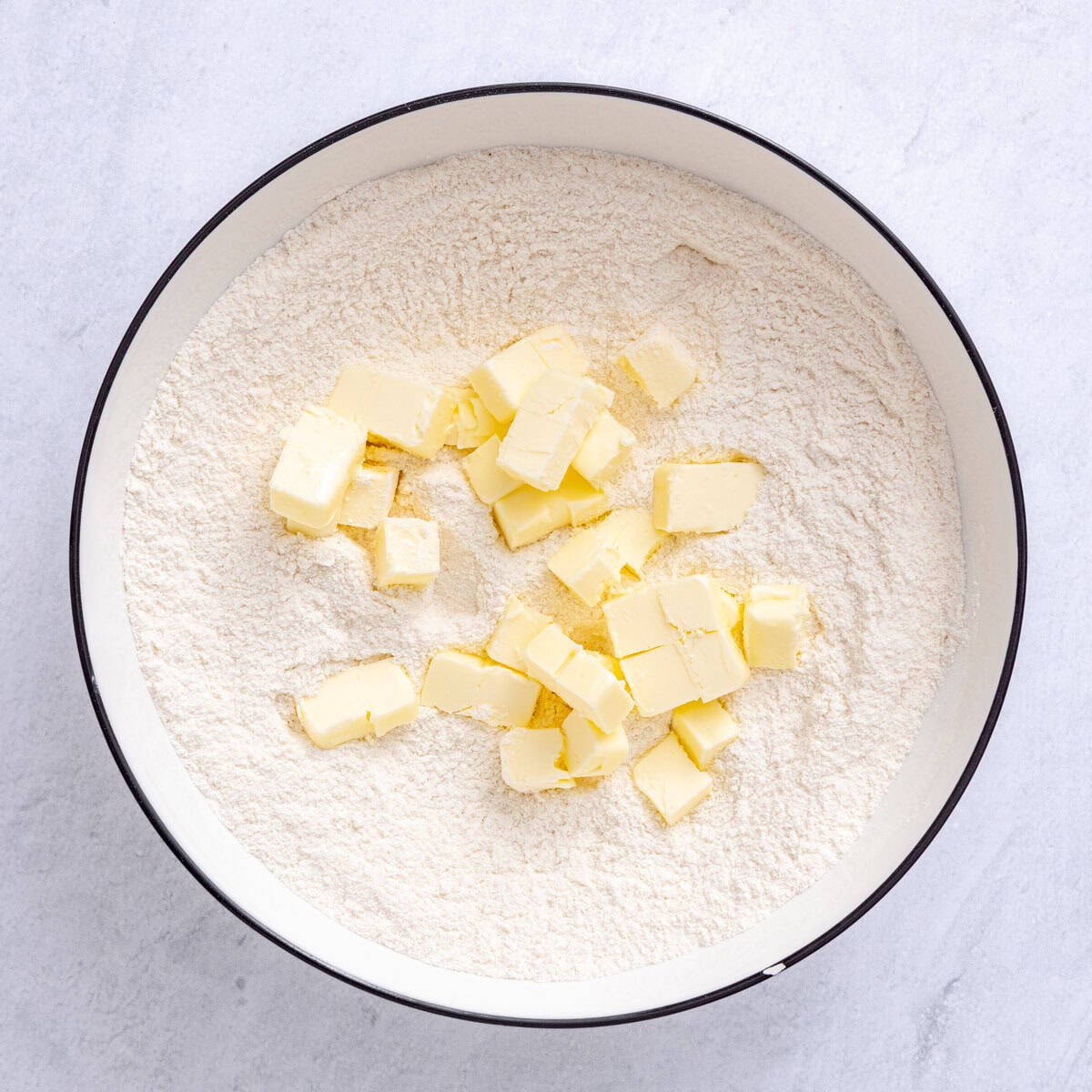 Flour, sugar, baking powder and salt in a medium bowl after combining with cold cubed butter added.