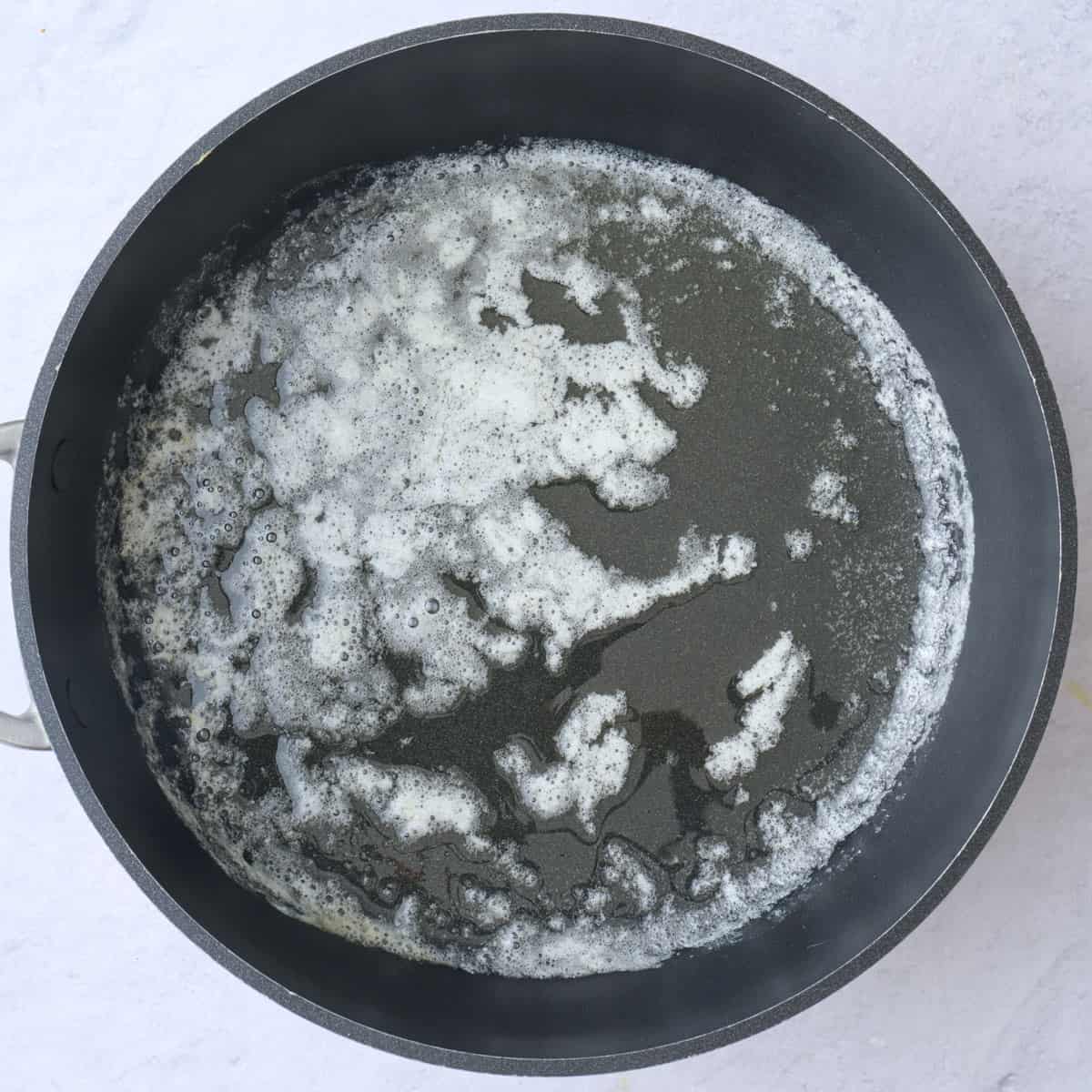 Melted butter in a saucepan.