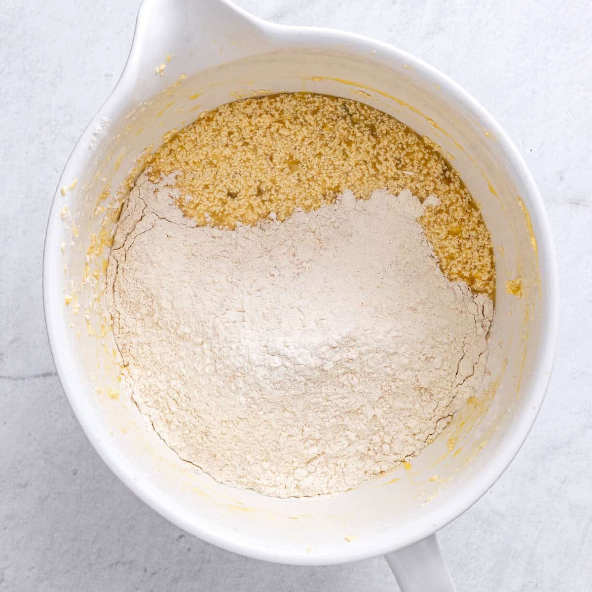 The bowl after combined with dry mixture added on to the side.