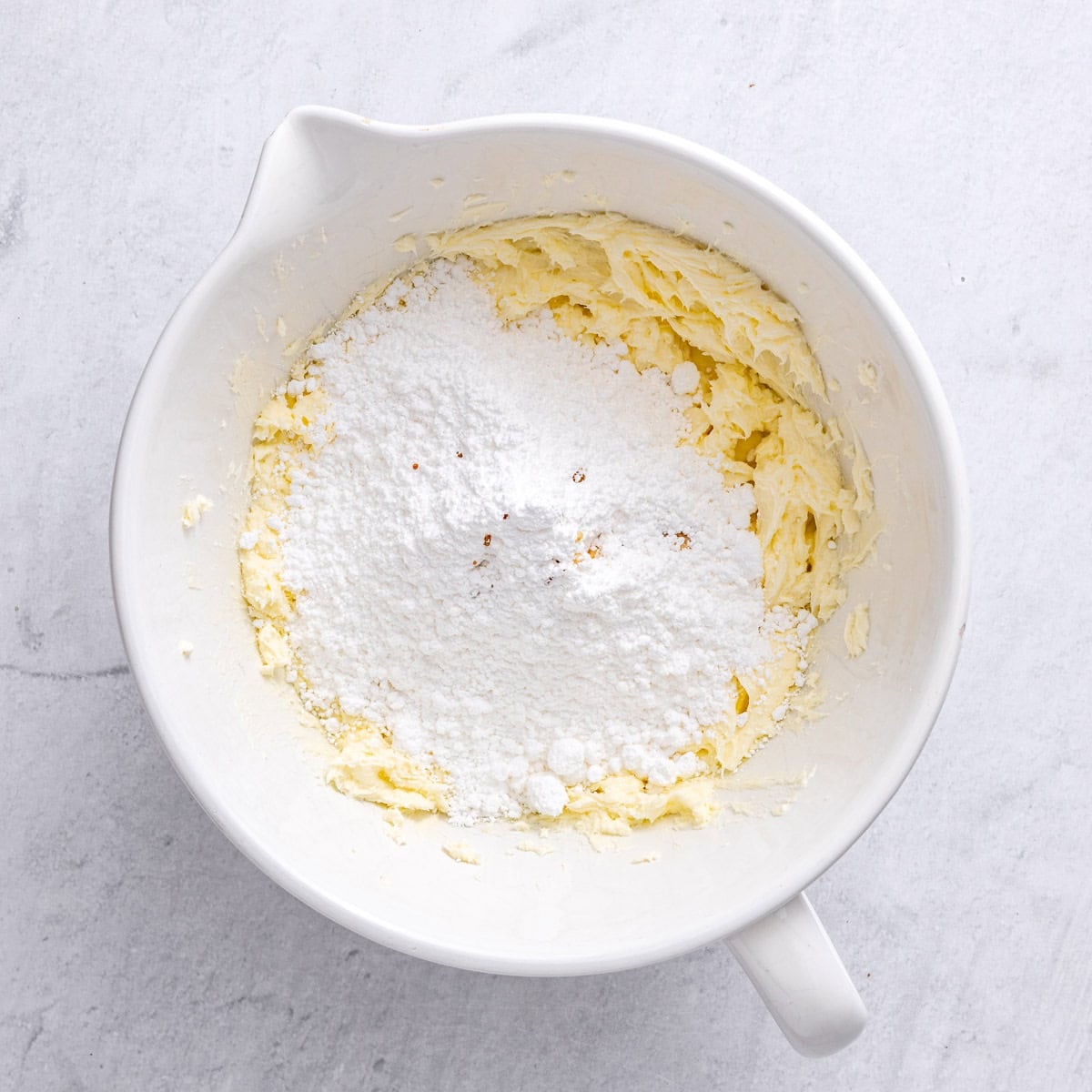 Cream cheese and butter after creaming with powdered sugar and vanilla added.