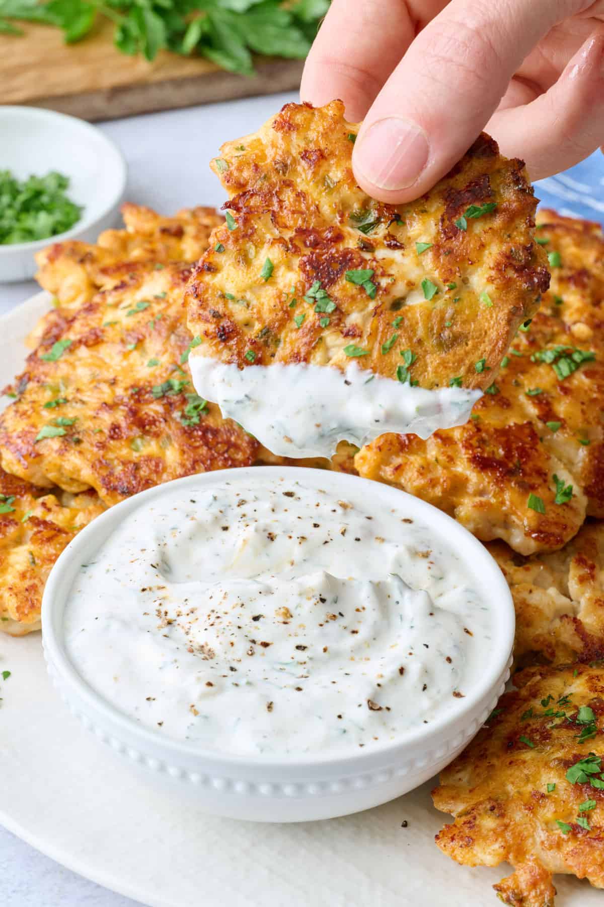 Dipping a chicken fritter into yogurt sauce.