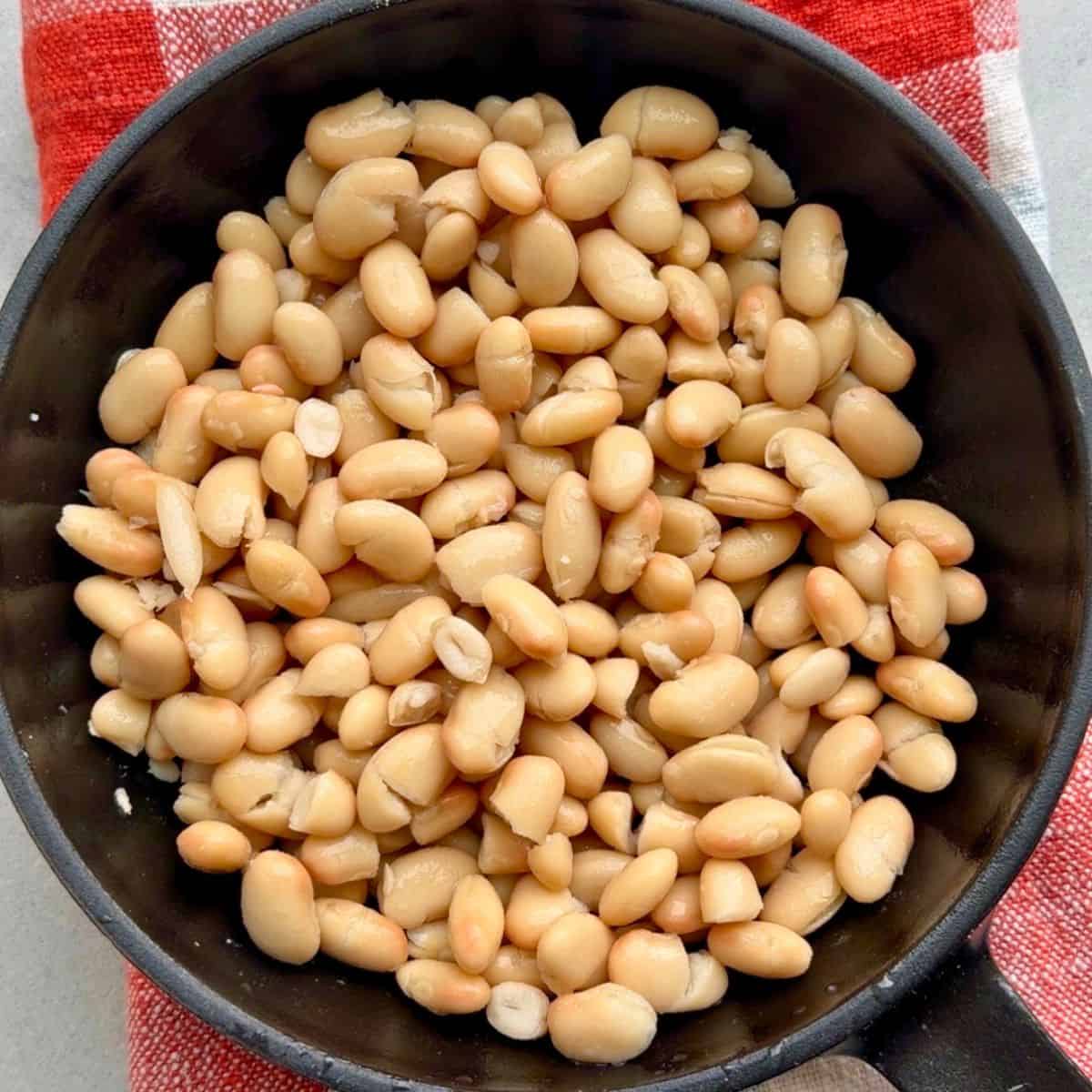Drained and rinsed white beans in a small skillet.
