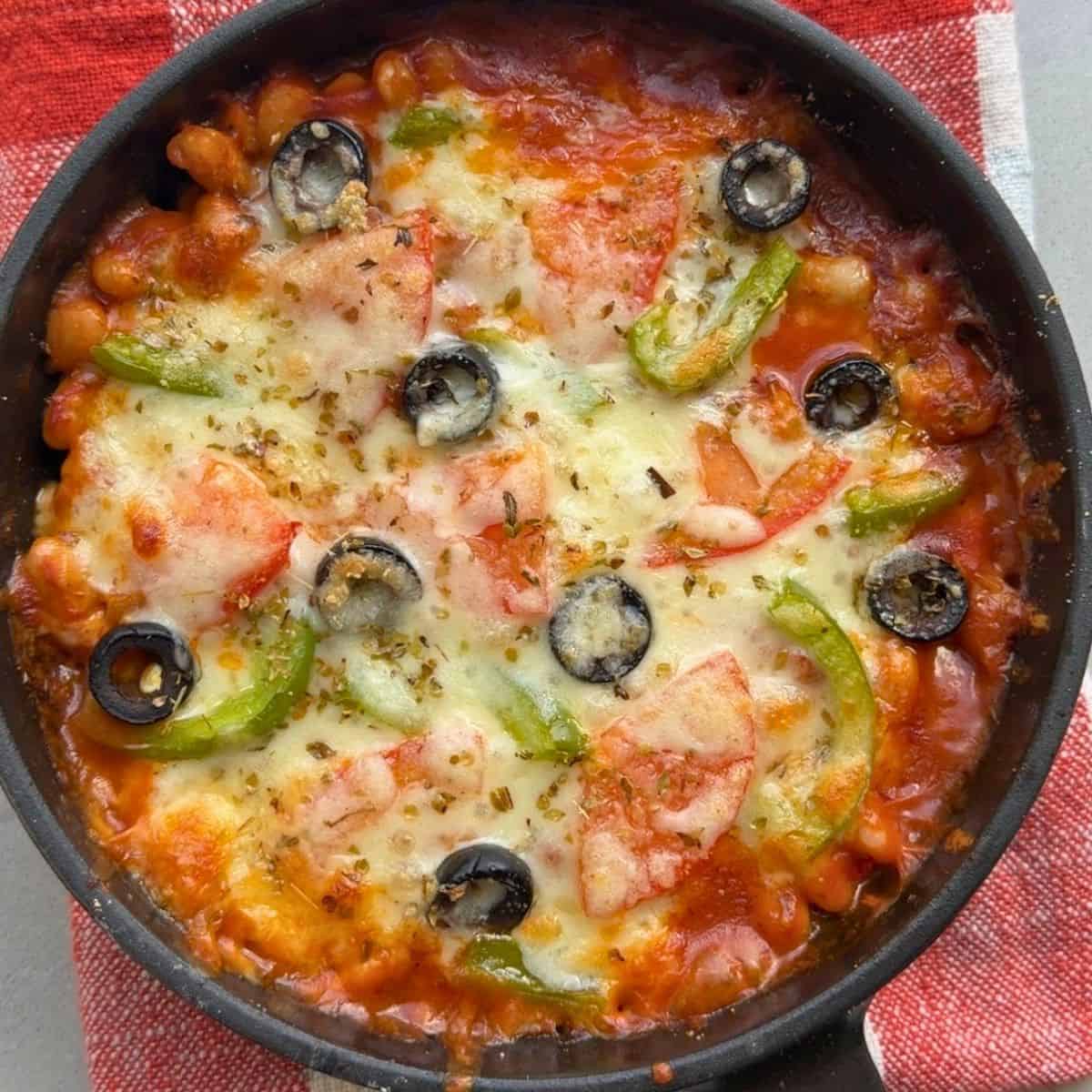 Pizza beans after baking with melty cheese.