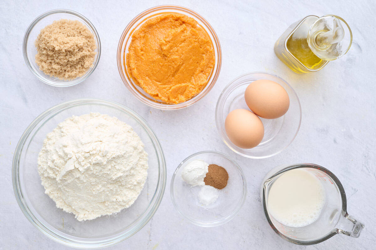 Ingredients for waffle recipe: mash sweet potatoes, brown sugar, flour, oil, eggs, milk, baking powder, cinnamon, and salt.
