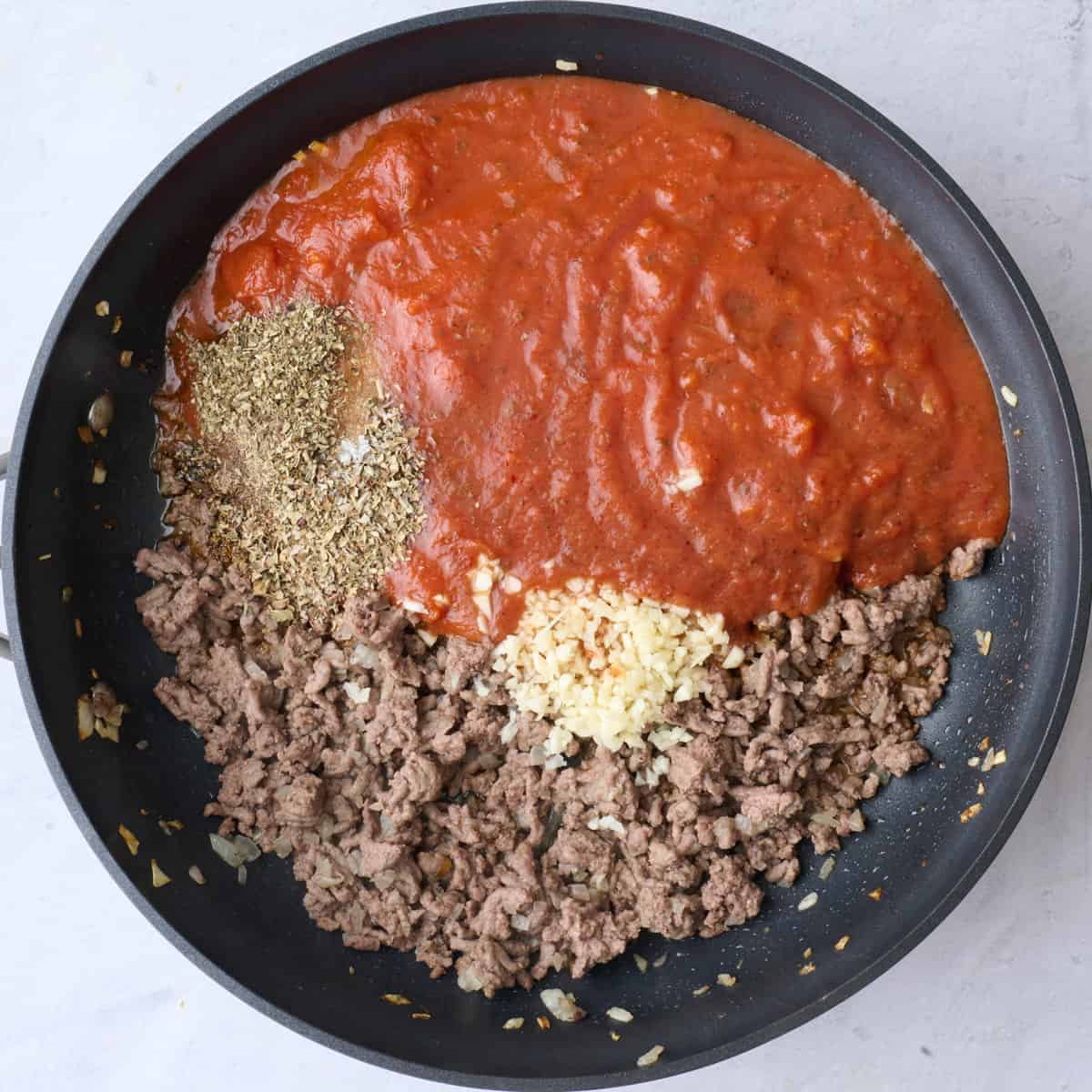 After cooking and browned through with garlic, marinara, and seasonings added before combining.