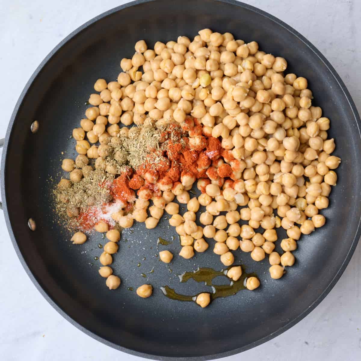 Chickpeas, oil and seasonings in a large skillet before combining.