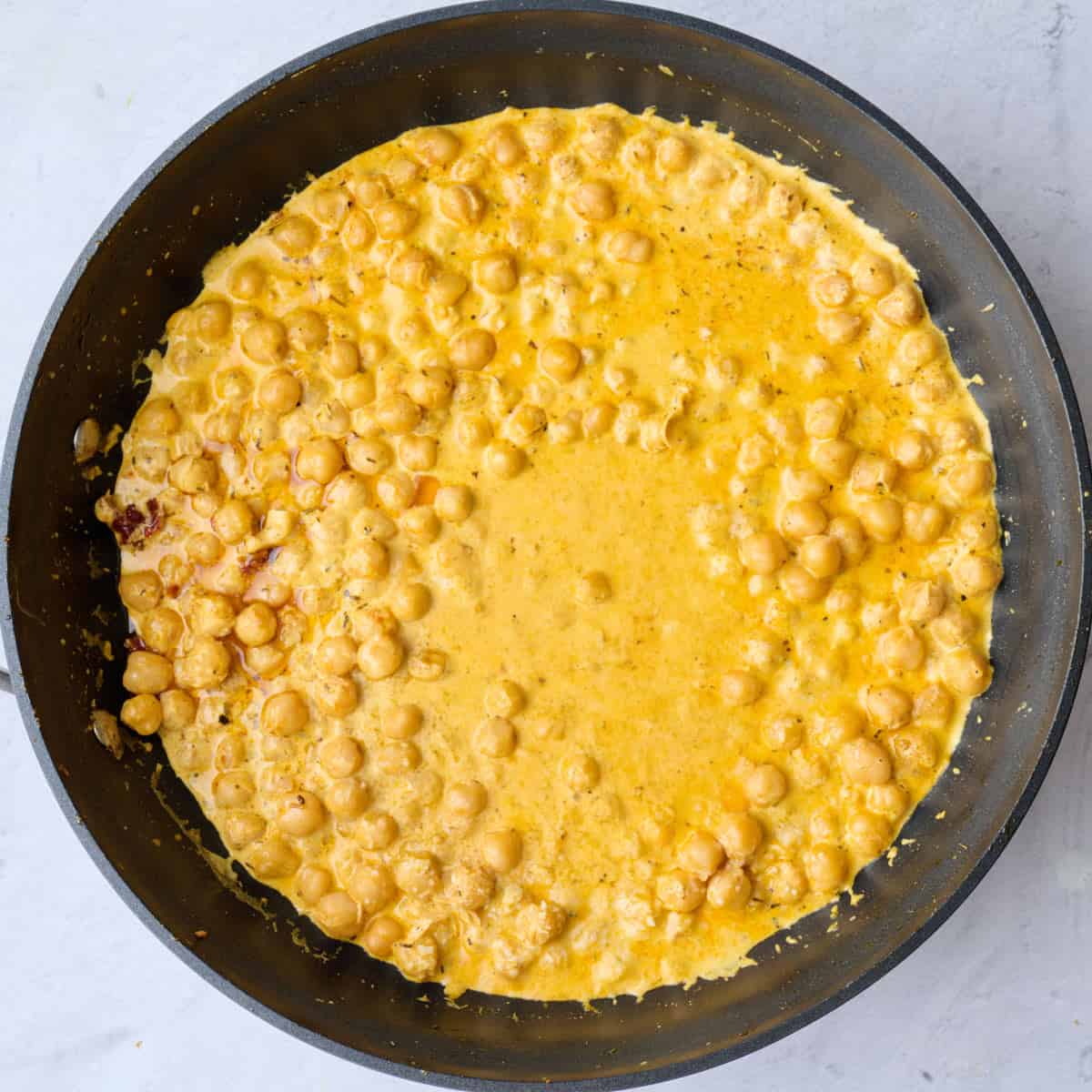 After sauce is slightly thickened and creamy.
