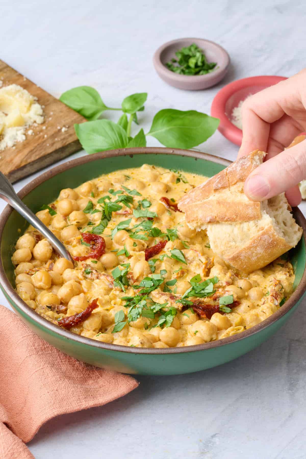 Chickpeas served in a shallow bowl with crusty bread for dipping.