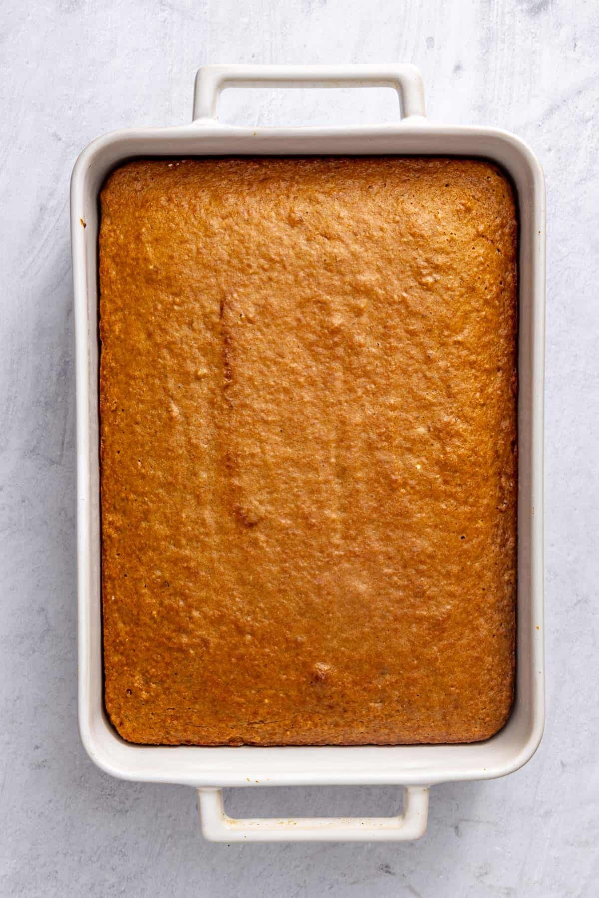 Cake in a ceramic baking dish after baking.