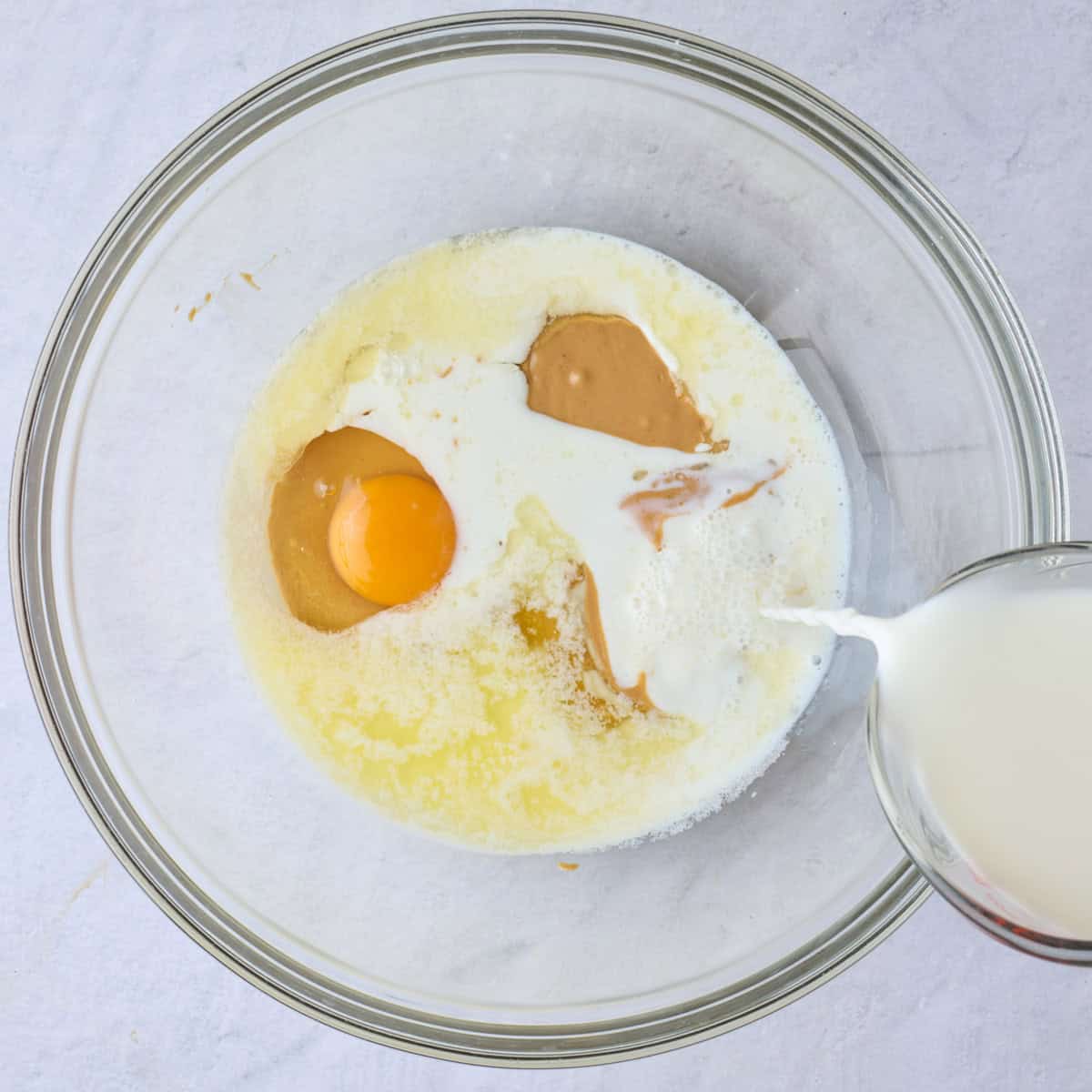Egg and milk added to the bowl, before whisking