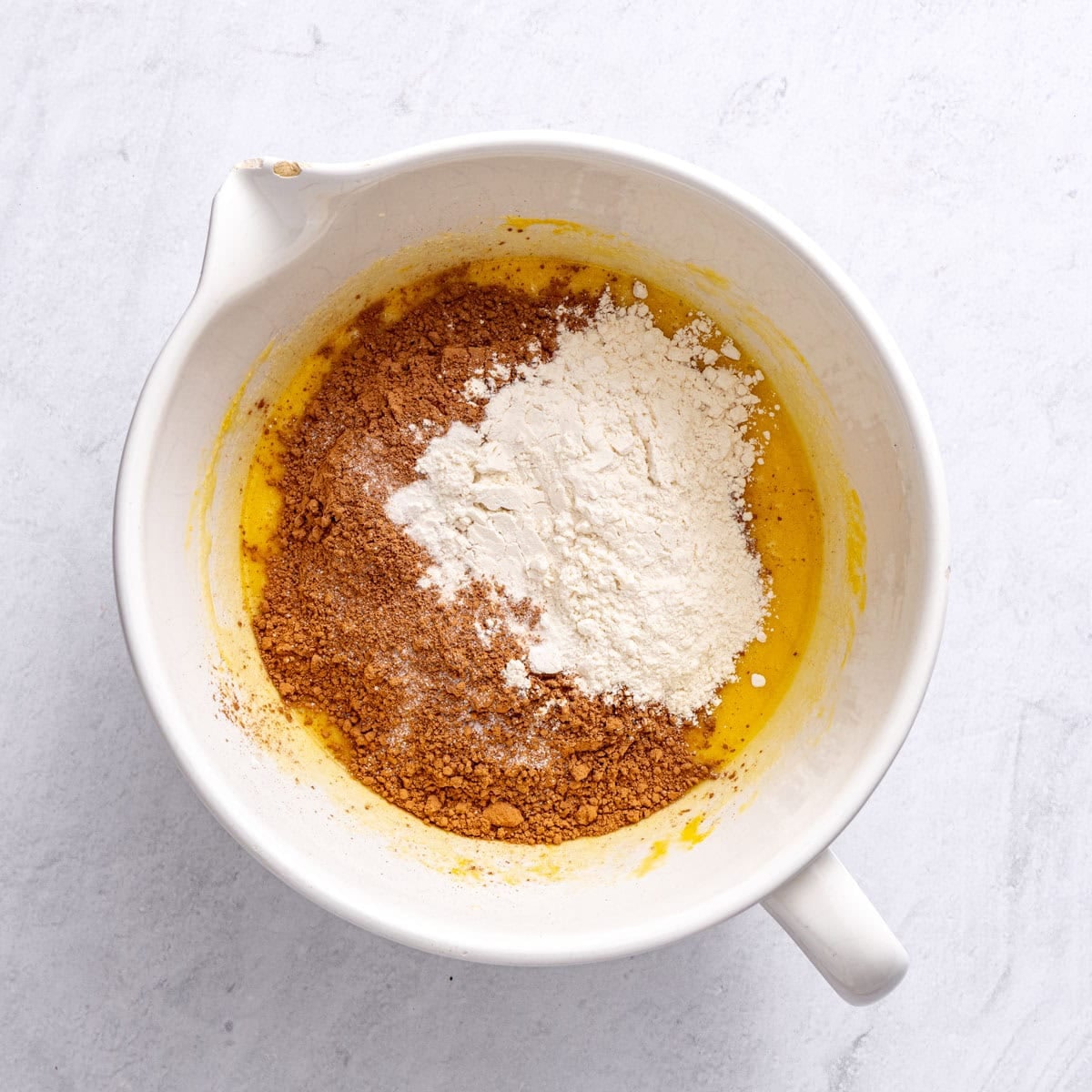 After whisking the eggs and vanilla into the batter with cocoa powder, flour and salt added before folding together.